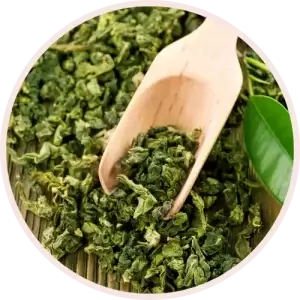 Green Tea Extract in a bowl with a wooden spoon
